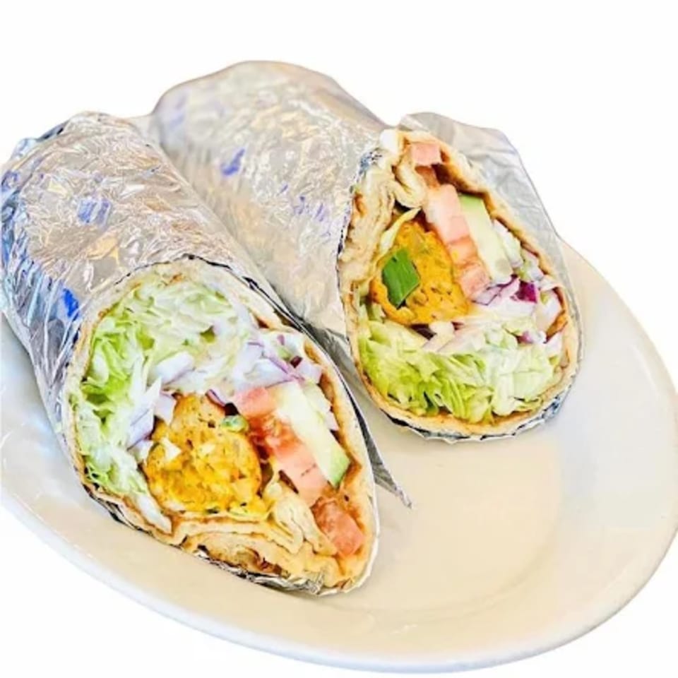 Two Chameli Restaurant Bangladeshi wraps, filled with chicken, lettuce, onions, and tomatoes, on a white plate.